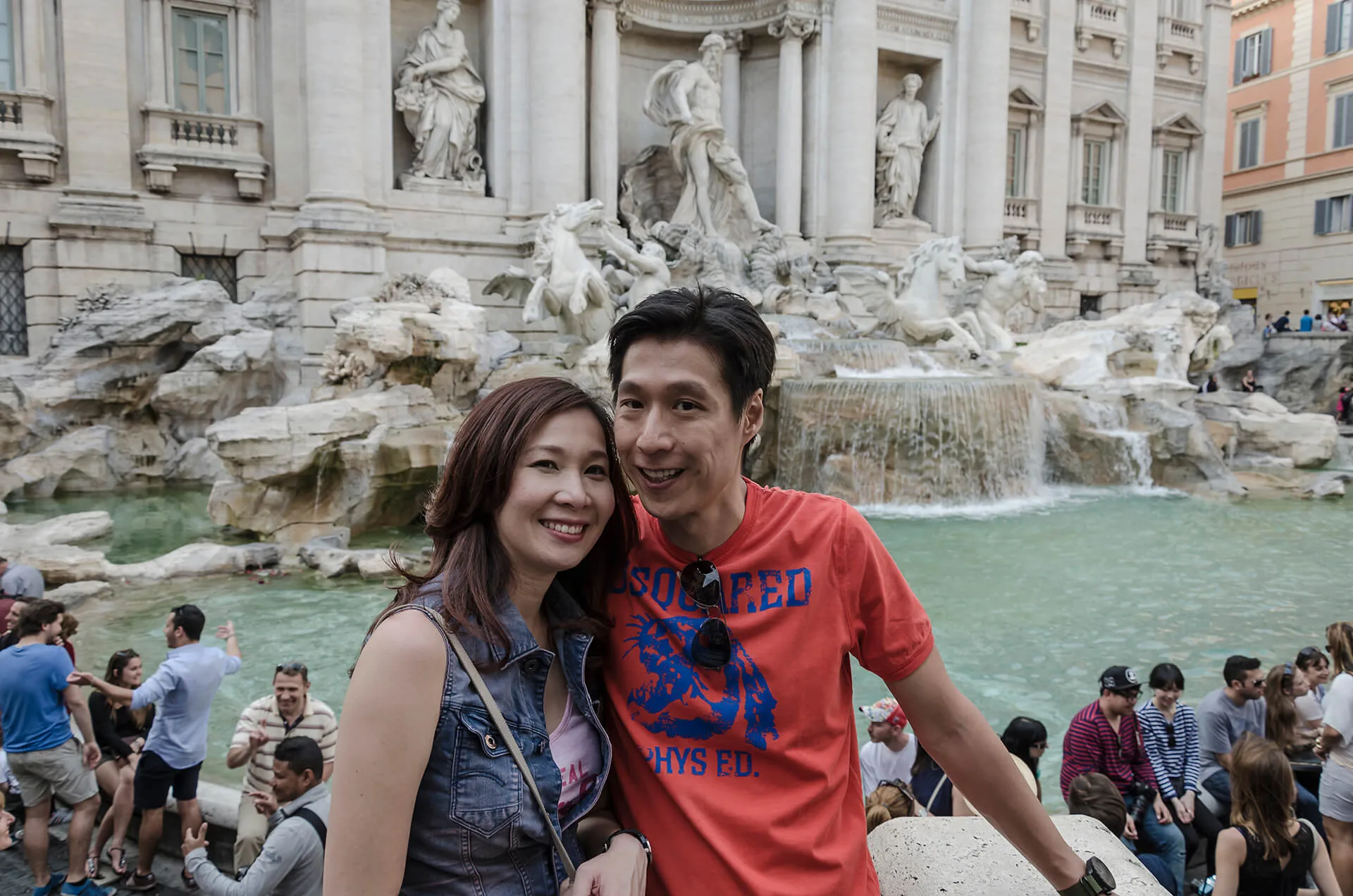 Asian couple in Trevi fountain Rome